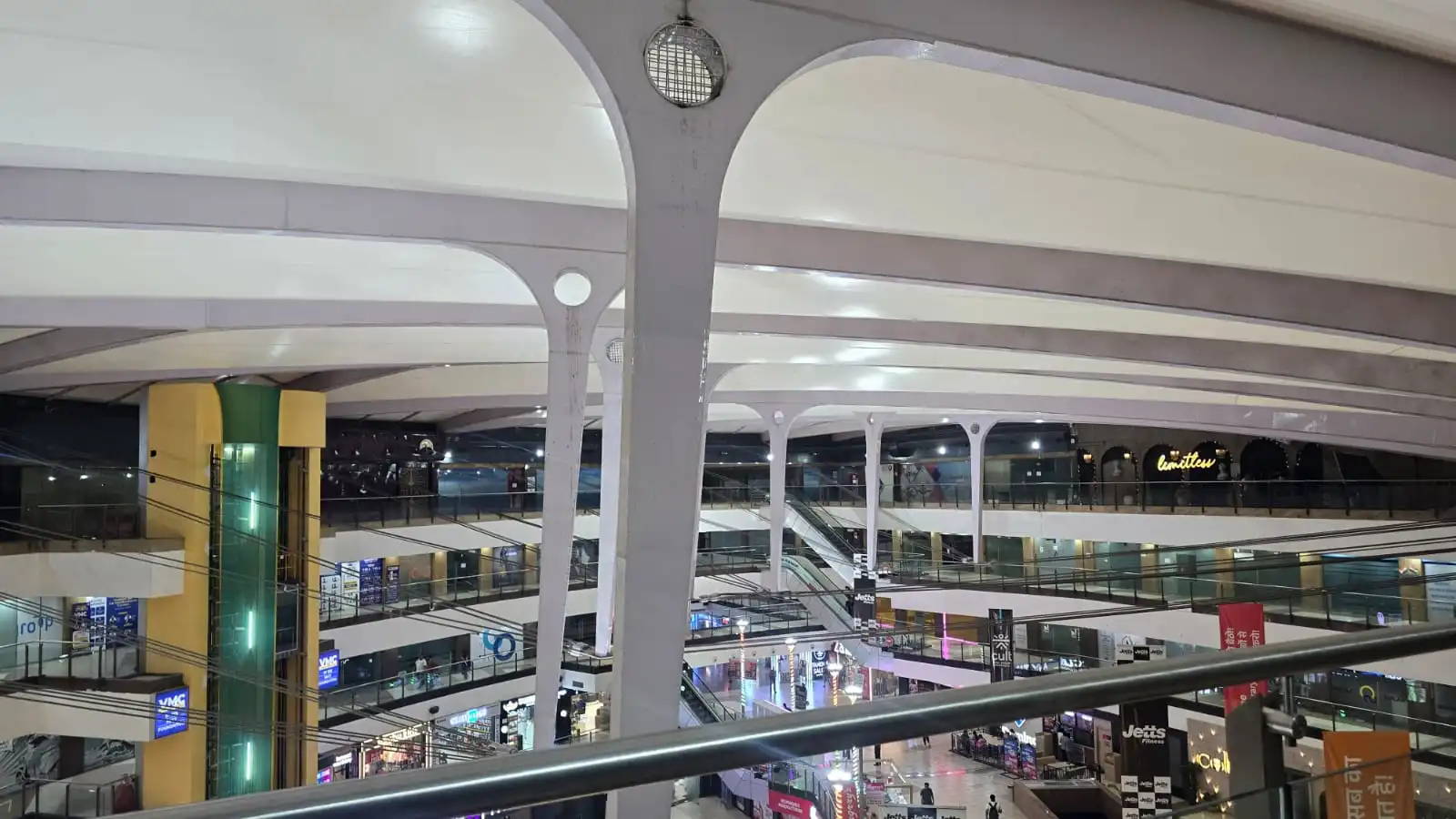 Vasant Square Mall Vasant Kunj — branching white columns carrying the curved edge beam, tensile membrane above and retail levels below, Ekra Decor